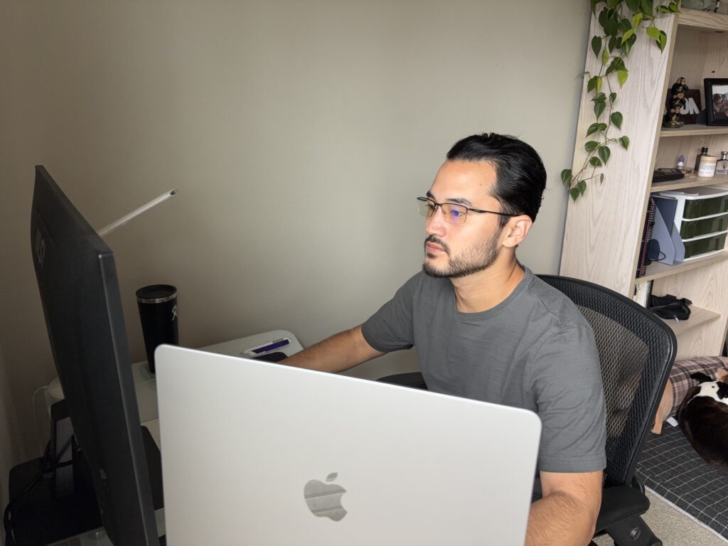 Toma Matisoff sitting at his desk working on a computer